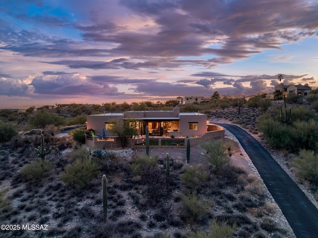 view of back house at dusk