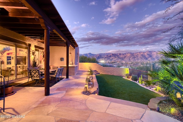 patio terrace at dusk with a mountain view