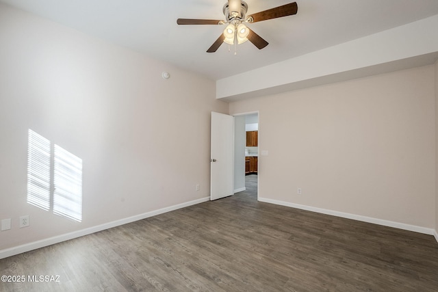 spare room featuring ceiling fan and dark hardwood / wood-style flooring