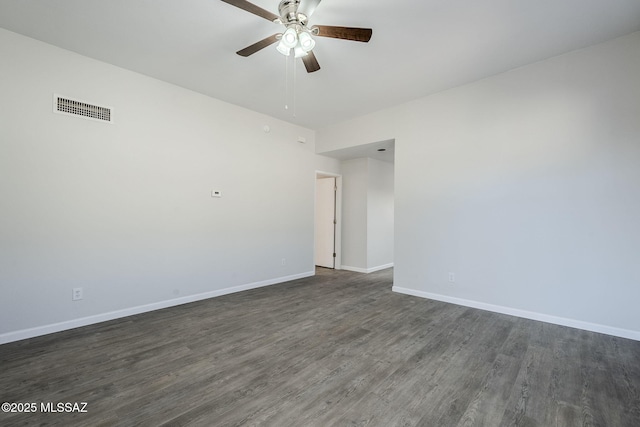 spare room featuring ceiling fan and dark wood-type flooring