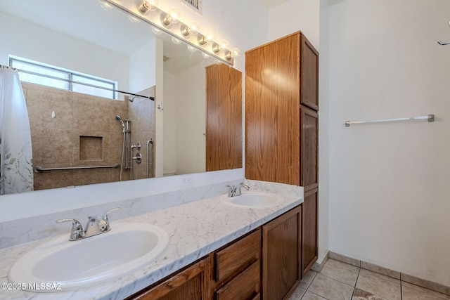 bathroom with tile patterned flooring, walk in shower, and vanity