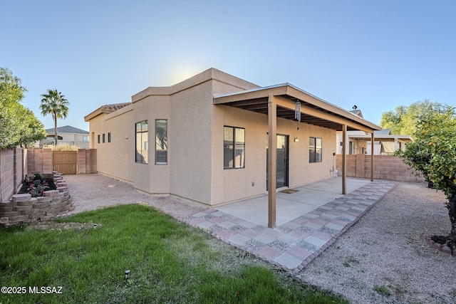 back of property with a patio