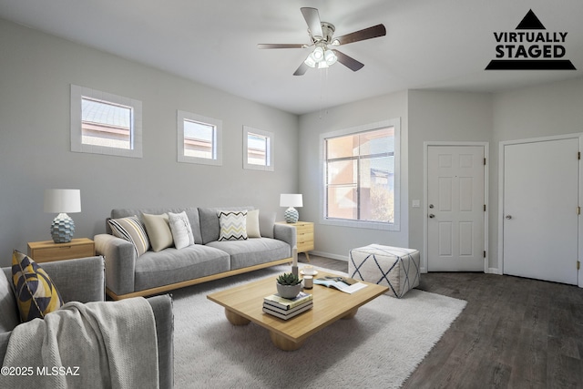 living room featuring ceiling fan and dark hardwood / wood-style floors