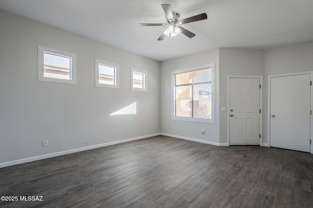 empty room featuring ceiling fan and dark hardwood / wood-style flooring