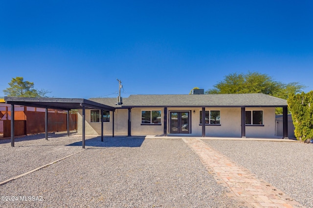 ranch-style house featuring a carport