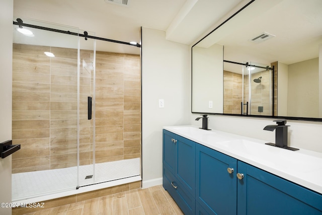 bathroom with vanity and a shower with shower door