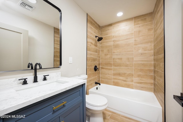 full bathroom featuring vanity, toilet, and tiled shower / bath