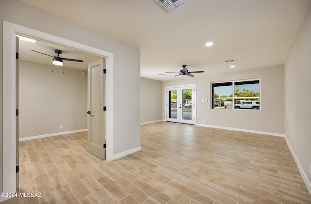 unfurnished living room with ceiling fan and french doors