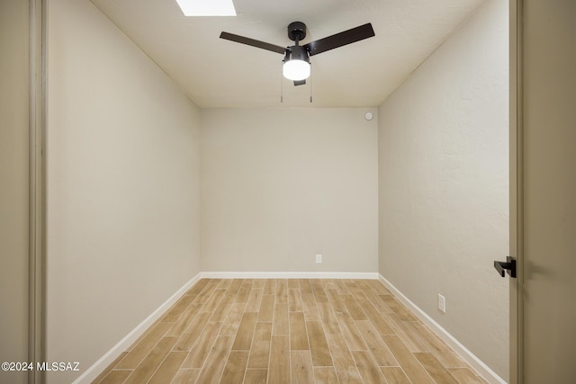 unfurnished room with ceiling fan and light wood-type flooring