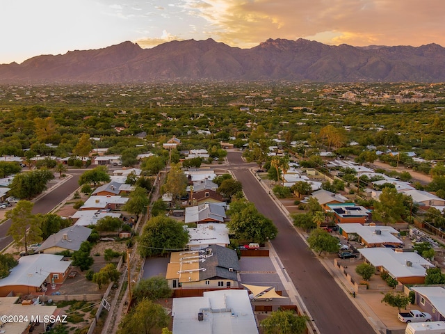 aerial view at dusk featuring a mountain view