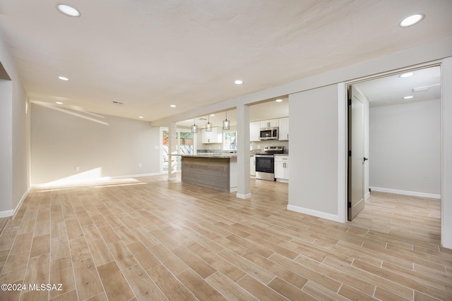 unfurnished living room featuring light hardwood / wood-style floors