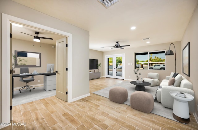 living room featuring ceiling fan and french doors