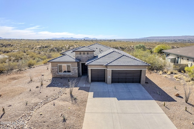 view of front of property featuring a garage and a mountain view