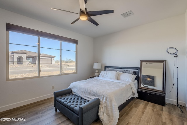 bedroom with ceiling fan and hardwood / wood-style floors