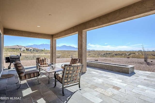 view of patio / terrace with a mountain view