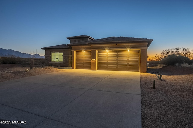 view of front of property with a mountain view and a garage