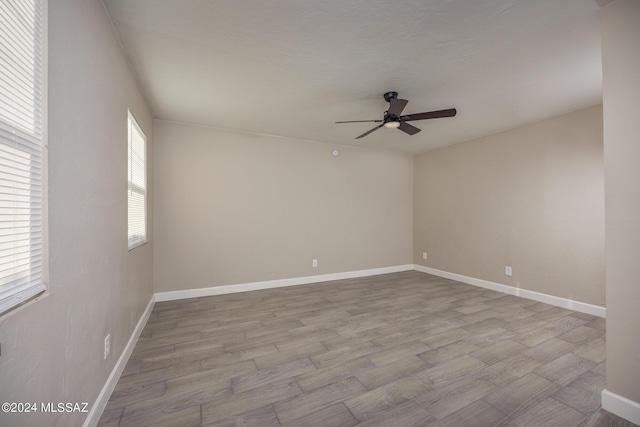 empty room featuring light hardwood / wood-style flooring and ceiling fan