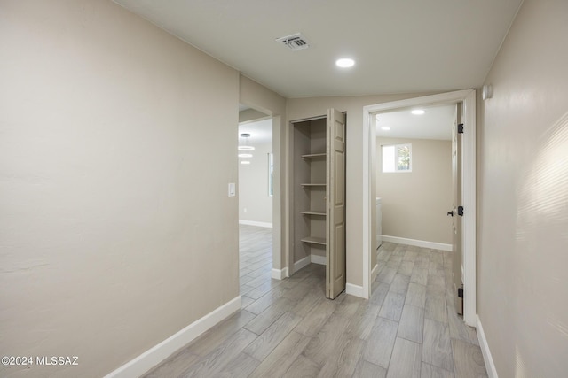 hall with light hardwood / wood-style flooring