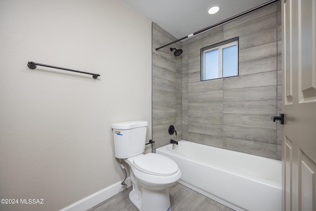 bathroom featuring hardwood / wood-style floors, tiled shower / bath, and toilet