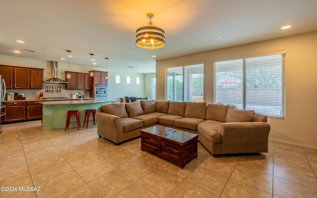 tiled living room featuring a notable chandelier