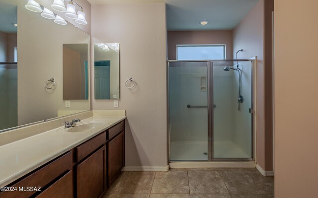 bathroom featuring tile patterned floors, vanity, and walk in shower