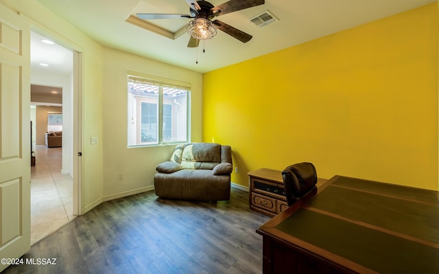 sitting room featuring ceiling fan and dark hardwood / wood-style floors