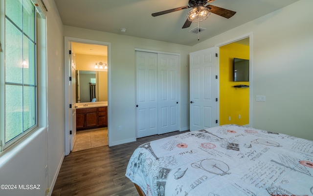 bedroom featuring ensuite bath, ceiling fan, a closet, and dark hardwood / wood-style floors