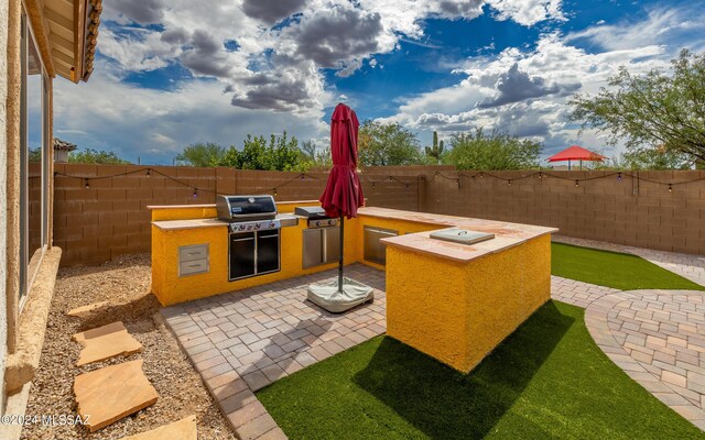 rear view of house with a gazebo, solar panels, a patio area, and a hot tub