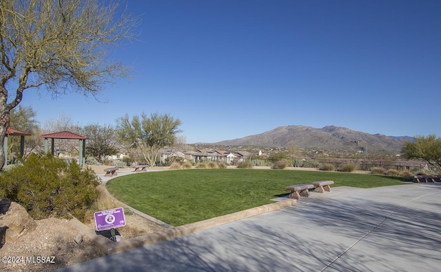 exterior space with a gazebo, a mountain view, and a lawn