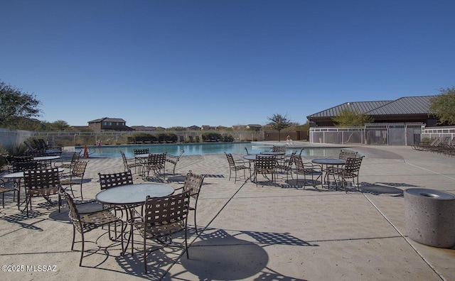 view of patio featuring fence and a community pool