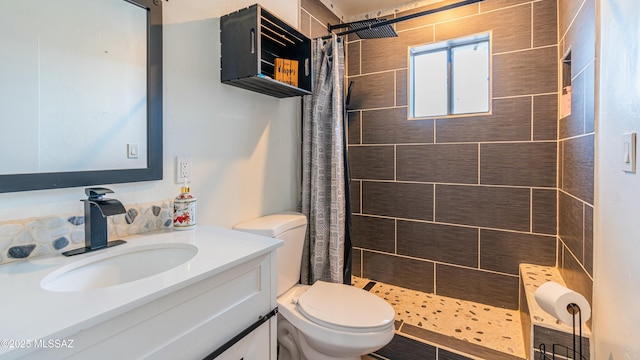 bathroom featuring a shower with curtain, toilet, and vanity