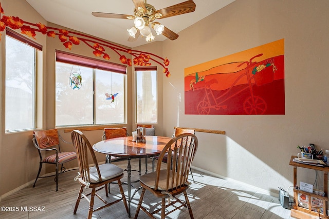 dining room featuring hardwood / wood-style floors, vaulted ceiling, and ceiling fan