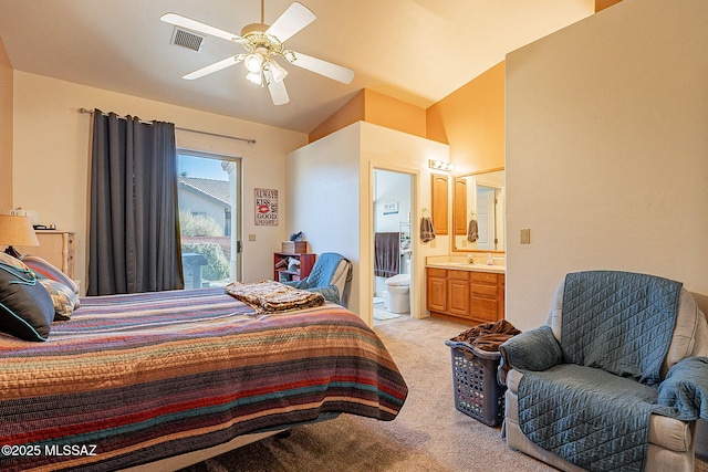 carpeted bedroom with connected bathroom, ceiling fan, lofted ceiling, and sink