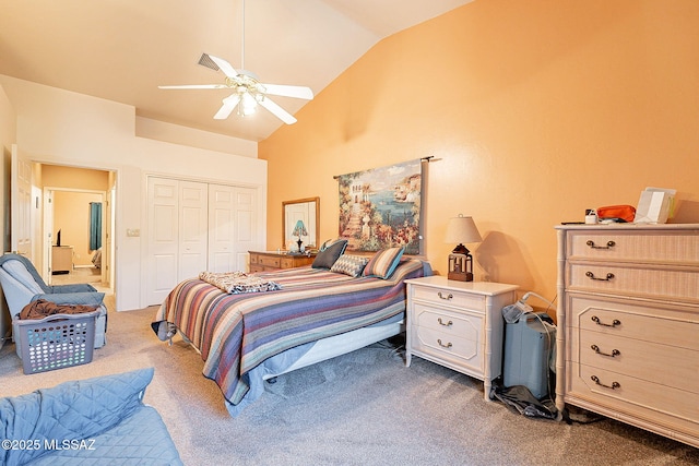 carpeted bedroom with ceiling fan, a closet, and high vaulted ceiling