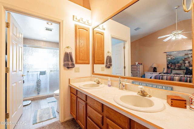 bathroom with vanity, hardwood / wood-style flooring, ceiling fan, toilet, and walk in shower