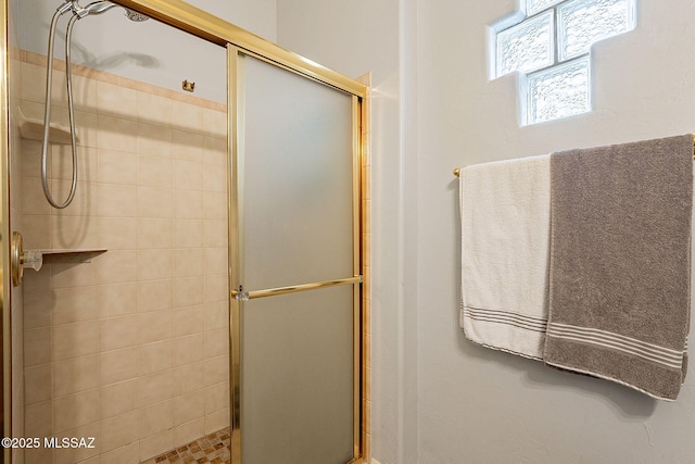 bathroom with a shower with shower door