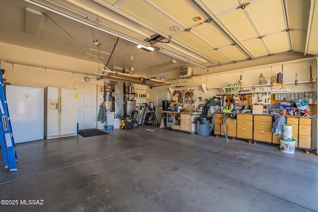 garage featuring a workshop area and a garage door opener