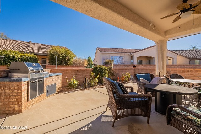 view of patio / terrace with ceiling fan, area for grilling, and a grill