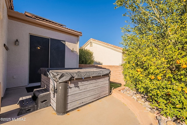 view of patio / terrace with a hot tub