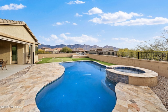 view of swimming pool featuring a mountain view, an in ground hot tub, and a patio