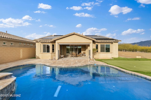 view of swimming pool with a mountain view and a patio