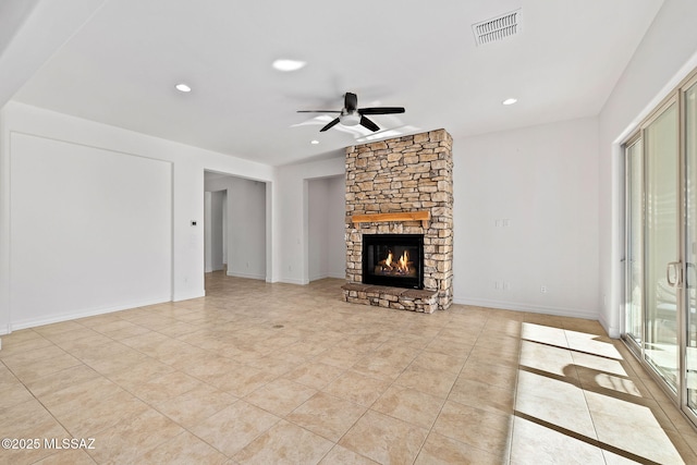 unfurnished living room with a fireplace, light tile patterned floors, and ceiling fan