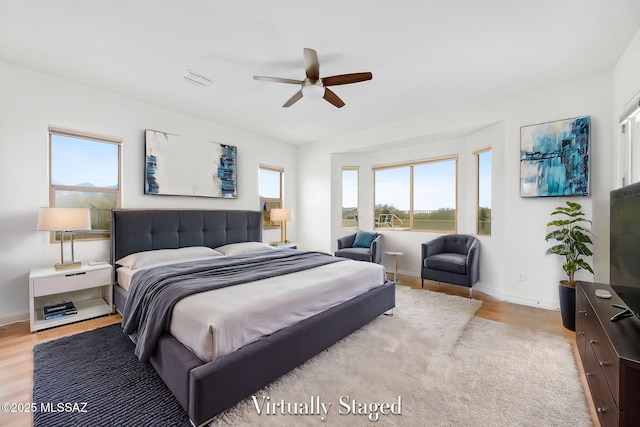 bedroom featuring light wood-type flooring and ceiling fan