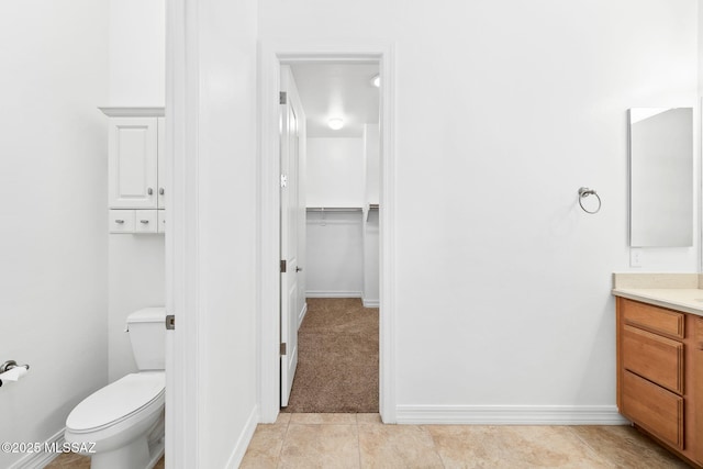 bathroom with tile patterned flooring, vanity, and toilet