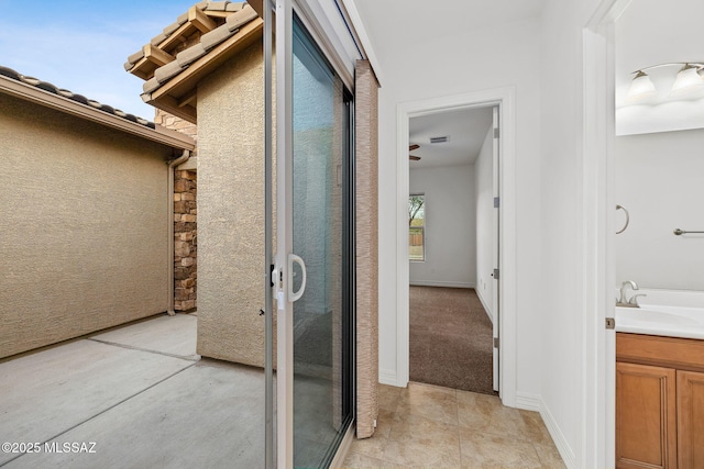 exterior space with vanity and tile patterned floors