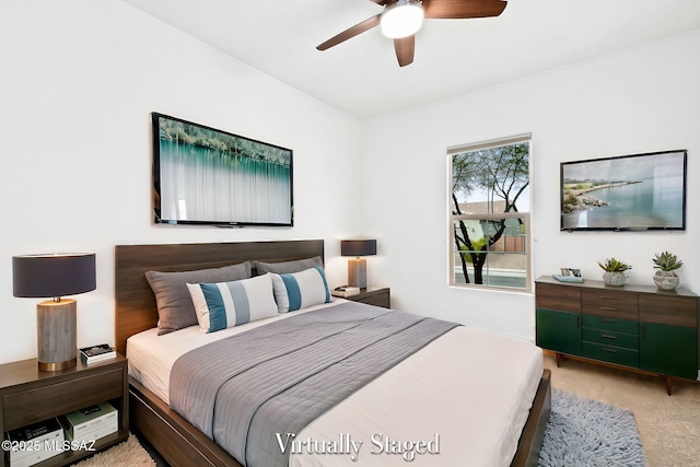 bedroom featuring ceiling fan and light carpet