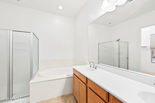 bathroom featuring tile patterned flooring, vanity, and separate shower and tub