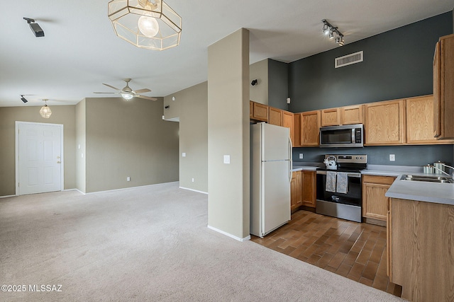 kitchen featuring stainless steel appliances, dark colored carpet, visible vents, open floor plan, and a sink