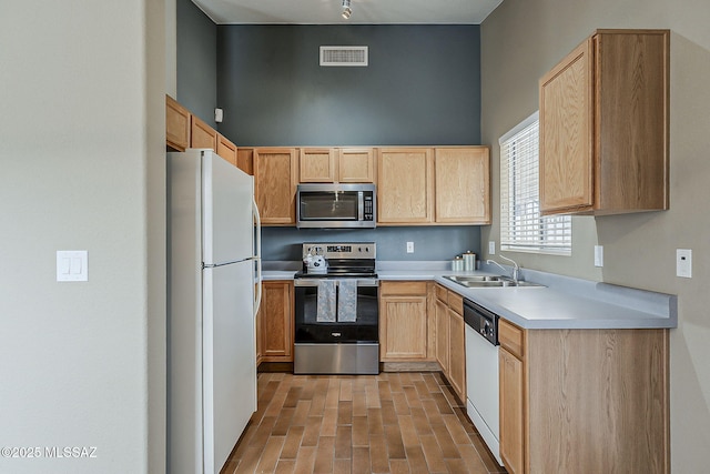 kitchen with visible vents, light brown cabinets, appliances with stainless steel finishes, and a sink