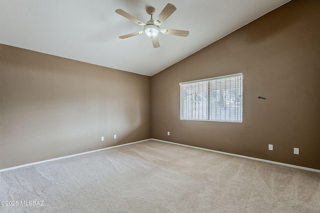 unfurnished room featuring lofted ceiling, ceiling fan, carpet, and baseboards